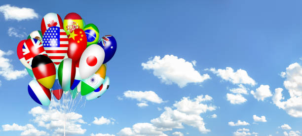istock Balloons with countries flags against panoramic blue sky with clouds banner background . Cooperation, tourism, peace and friendship concept 1618921270