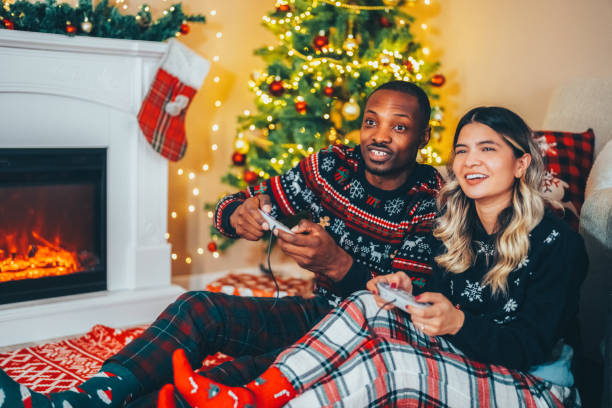 istock Happy couple on Christmas playing video games 1618927692