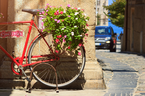Decorative bicycle near restaurant on Tropea street. Closeup details of old town street in summer time vacation. Selective focus.