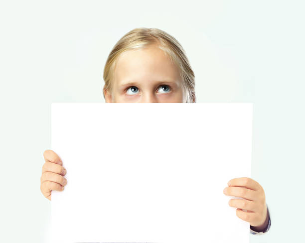 istock Cute blonde child girl holding white empty blank banner board with copy space on white background 1618933231