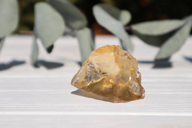 istock Citrine stone on a white wooden background. 1618933771