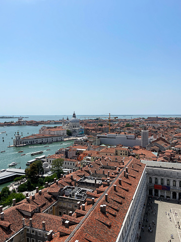 Stock photo showing close-up view of Piazza San Marco (St. Mark's Square), Museo Correr, Giardini Reali di Venezia (Royal Gardens of Venice), Le Zitelle, La Giudecca and terracotta rooftops of residential buildings viewed from St Mark's Campanile (bell tower).