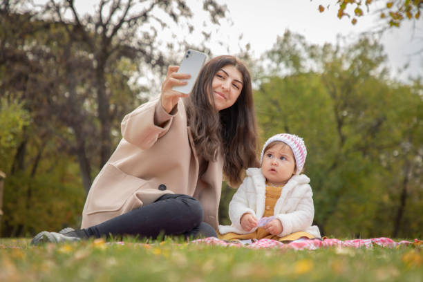 istock Mother and daughter taking selfie in nature 1618980612