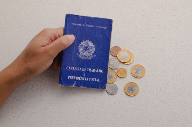 istock Brazilian work card displayed with money from Brazil, representing the labor document that includes FGTS, INSS, unemployment, salary, CTPS and CLT. 1618983400