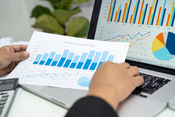 istock Asian accountant working and analyzing financial reports project accounting with chart graph in modern office, finance and business concept. 1618986078