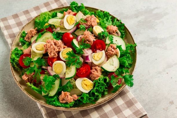 istock Tuna salad, vegetable salad with quail eggs, lettuce, red onion and cucumbers, on a light gray table, keto food, lifestyle, healthy eating, selective focus, top view, no people, 1618991621