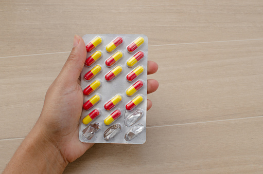 Closeup of medicine, pills and pills in vibrant shades of yellow and red, representing vitality and health. Perfect for illustrating treatments, medical care, pharmacy and wellness.