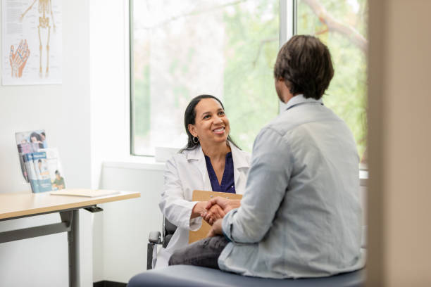 istock Female surgeon shakes hands with her patient while introducing herself 1618993291