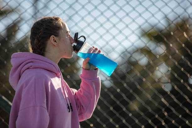 istock Young female athlete is drinking energy drink. 1618995021