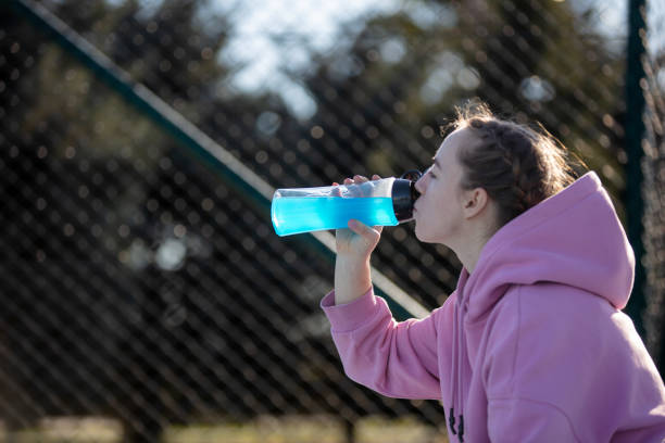 istock Young female athlete is drinking energy drink. 1618998262