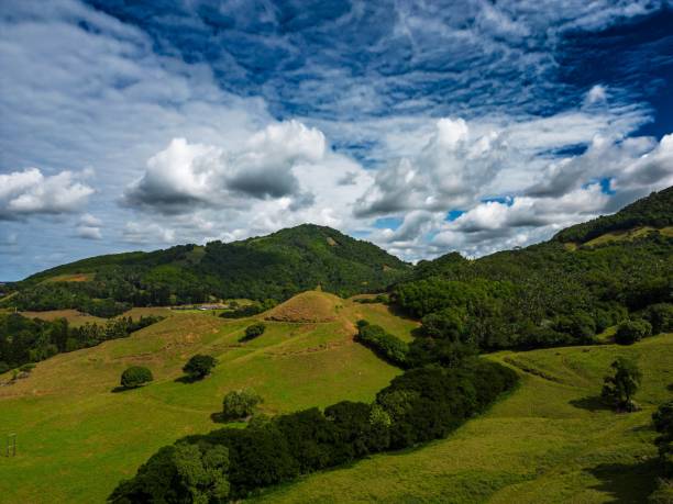 istock Scenic view of green hills under a cloudy blue sky 1619015908