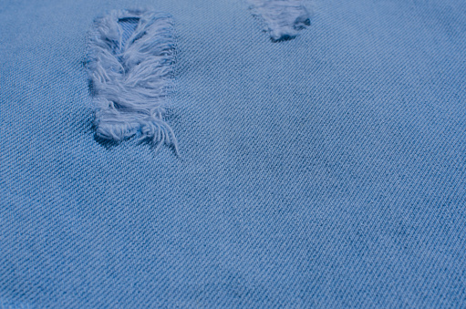 Close-up of a denim texture in detail, revealing the intertwined lines that bring the fabric to life. Perfect for fashion, clothing and lifestyle related projects.