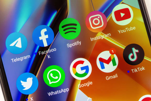 Adygea, Russia - August 11, 2023: telegram, facebook, spotify, instagram, youtube, twitter, whatsapp, google, gmail, tik tok mobile app icons on xiaomi poco smartphone screen closeup