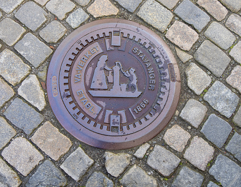 Manhole cover in the old town of Stavanger (Gamle Stavanger) in Norway, Northern Europe