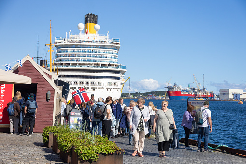 Tourists arriving from a large cruise ship in the Norwegian port of Stavanger, in Norway.