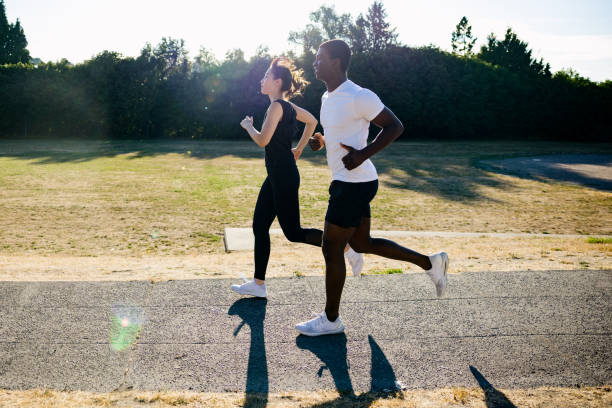 istock Interracial Couple Enjoying a Run On A Sunny Day 1619043787