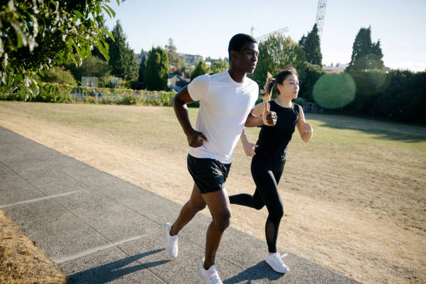 istock Interracial Couple Enjoying a Run On A Sunny Day 1619045407