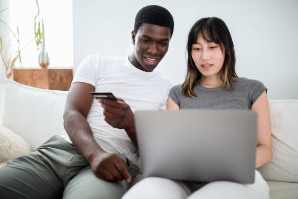 istock Young Interracial Couple Using Laptop Together 1619050214