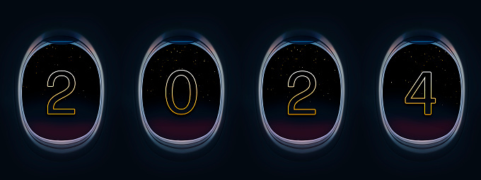 Year 2024 in airplane window at night and golden stars .Traveling by plane to celebrate New Year.