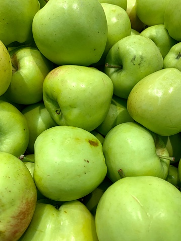 A view of a display of green apples