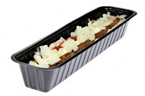 Dutch frikandel speciaal in a black plastic container Dutch frikandel speciaal in a black plastic container isolated on white background frikandel speciaal stock pictures, royalty-free photos & images