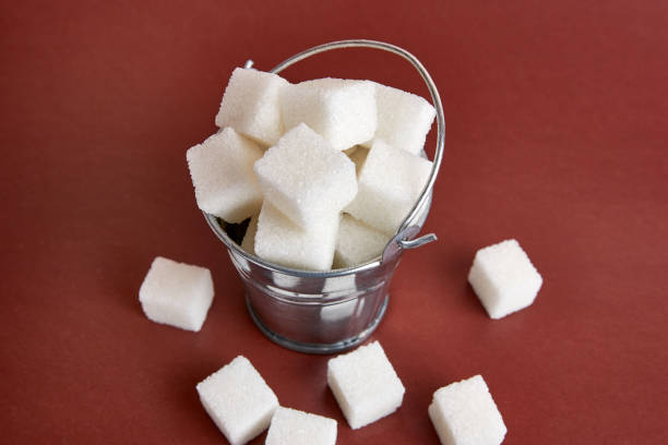 istock A small bucket with cubes of pressed sugar on a brown background. 1619073252