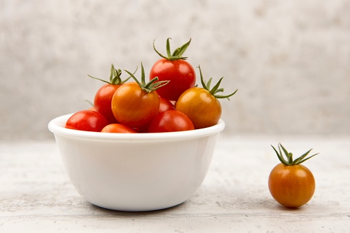 Cherry Tomatoes in a bowl isolated on white background.