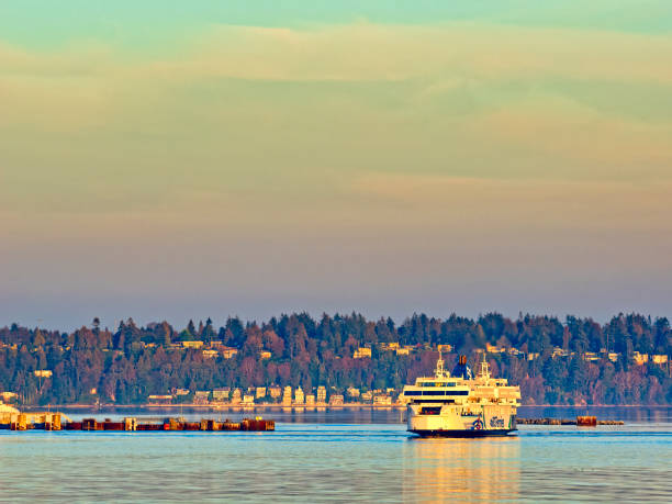 Seattle WA, USA - July 26, 2024: A Washington State Ferry makes its way across Elliott Bay to Bainbridge Island during a Summer sunset.