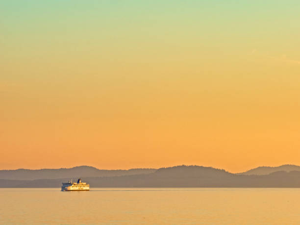 The coast of Vancouver Island in British Columbia  Canada on October 05, 2022:  Ferry service connecting Vancouver Island to the mainland coast of British Columbia at sunset