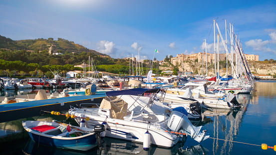 Panorama of yacht port of Tropea town. View on port and green mountains landscape.