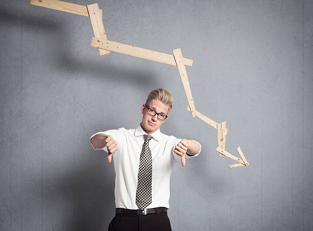 istock Upset businessman in front of descending graph. 161909489
