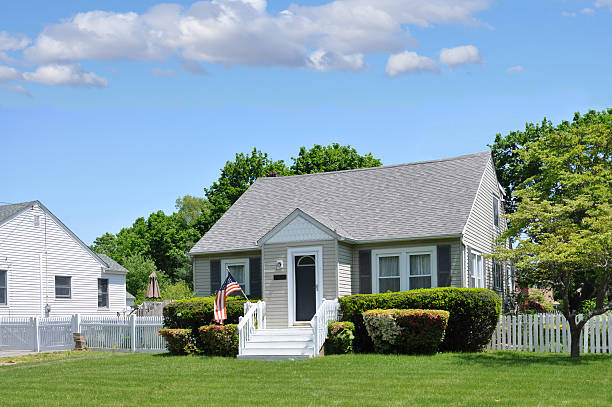 Large new American House in red brick with lovely green lawn in summer