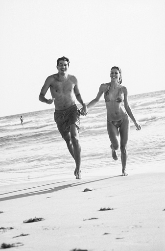 Couple running on the beach, Margarita Island, Venezuela