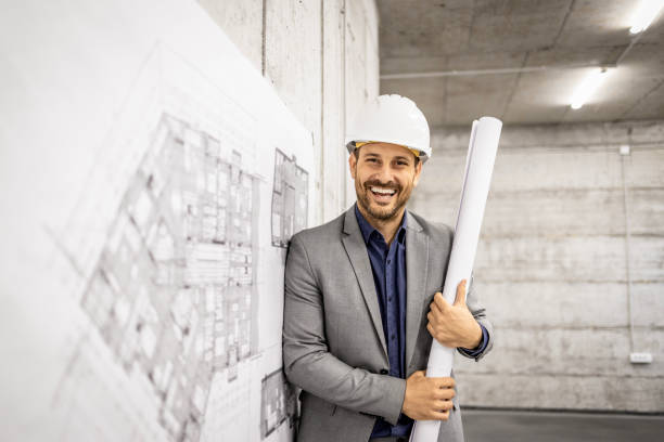 istock Portrait of caucasian architect or construction engineer holding blueprint inside building site. 1619108729