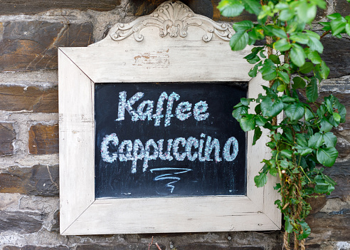Chalkboard at a German cafe/restaurant with the text Kaffee and Cappuccino
