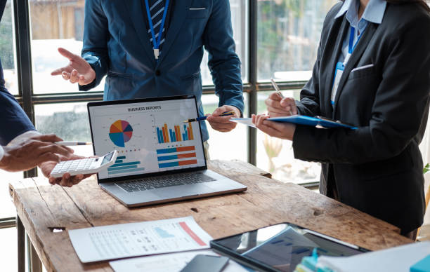 istock Business team analyzing income charts and graphs with modern laptop computer. Business analysis and strategy concept. 1619165078