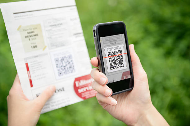 Scanning advertising with QR code on mobile phone stock photo