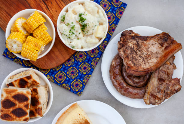 Heritage Day braai South African Braai Day or Heritage Day. Celebrating traditional braai food.
Meat and sides with traditional Shwe - Shwe cloth. south african braai stock pictures, royalty-free photos & images