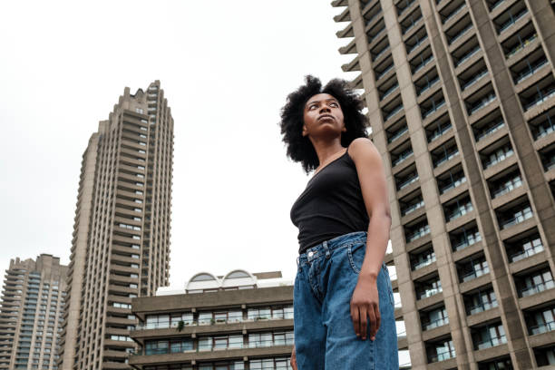 istock Serious black woman surrounded by skyscrapers. 1619181041