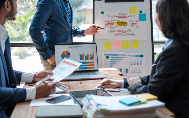 istock Business team analyzing income charts and graphs with modern laptop computer. Business analysis and strategy concept. 1619189531