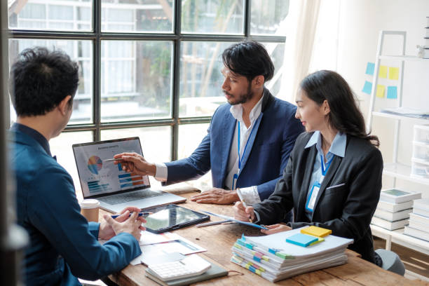 istock Business team analyzing income charts and graphs with modern laptop computer. Close up.Business analysis and strategy concept. 1619196548