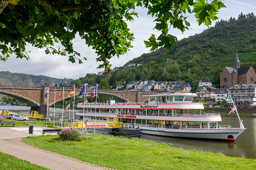 Cochem, Germany - August 8th 2023: Ferry boat at Cochem \n\nCochem is the seat of and the biggest town in the Cochem-Zell district in Rhineland-Palatinate, Germany. With just over 5,000 inhabitants, Cochem falls just behind Kusel, in the Kusel district, as Germany's second smallest district seat. Since 7 June 2009, it has belonged to the Verbandsgemeinde of Cochem. \nSource: Wikipedia