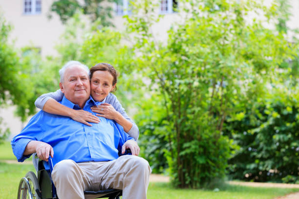 istock Senior man sitting on a wheelchair with caregiver 161921921