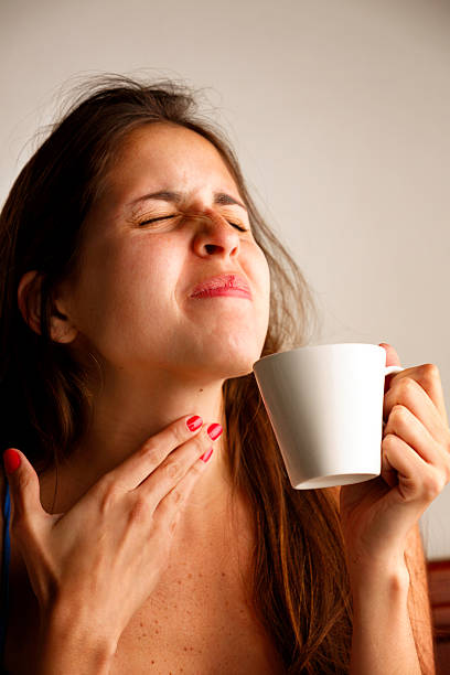 Young woman with sore throat stock photo