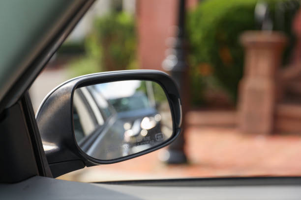 istock Car mirror: Reflection of journey, introspection, and transitions in a compact frame, capturing the road of life 1619222634