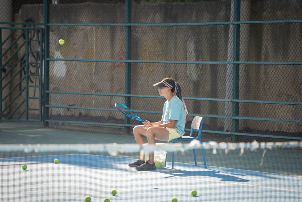 istock Female Tennis instructor giving tactics to her student 1619223318