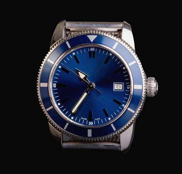 Blue wristwatch on a black wooden table close up