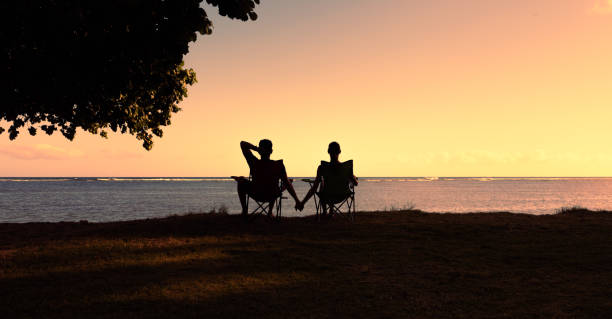 istock Couple enjoying beautiful sunset at the beach. 1619236457