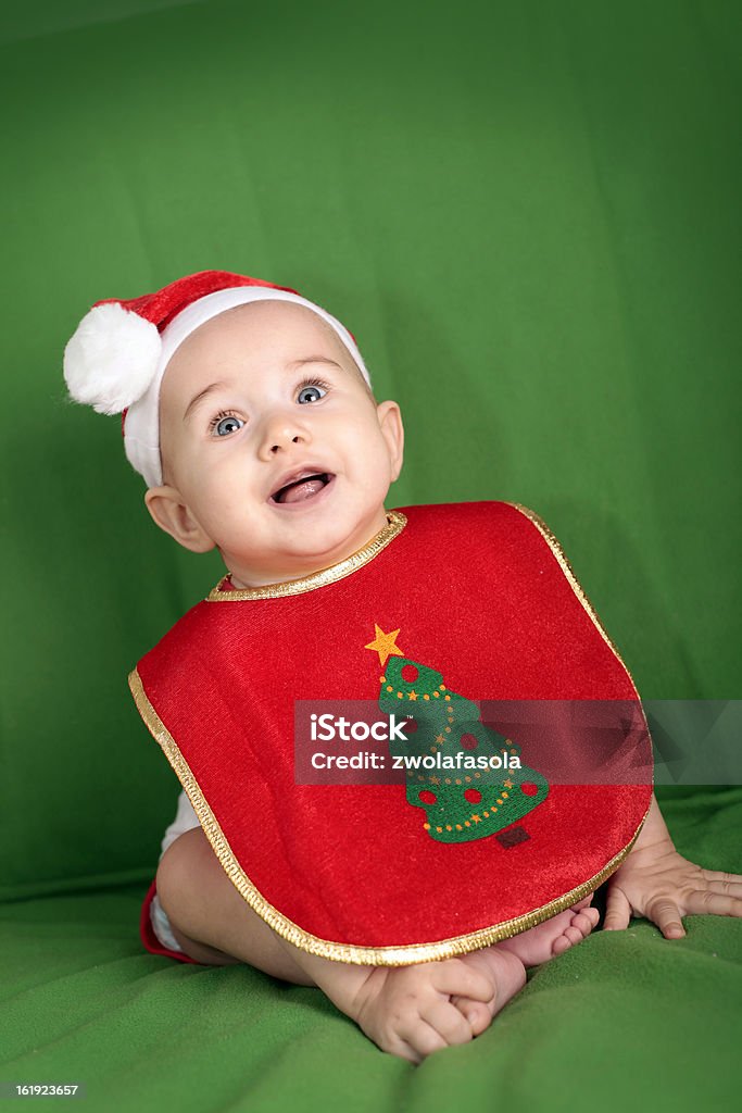 Santa baby Happy little baby in Santa Hat and Christmas Bib 6-11 Months Stock Photo