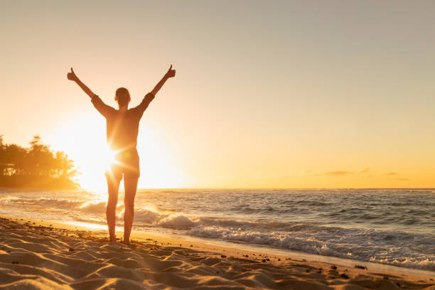 istock Young female feeling grateful, joyful, positive, standing outdoors in the sunrise. 1619237599